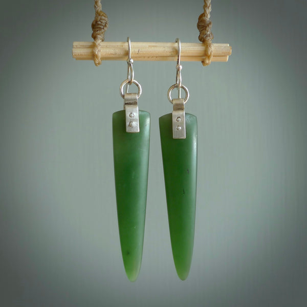 These are stunning large wing shaped drop jade earrings carved in New Zealand by Josey Coyle. It is carved from a deep green piece of New Zealand Jade and with Sterling Silver hooks and findings.