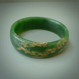 Hand carved jade bangle. Carved from green New Zealand jade. This is a solid jade bangle carved from a single piece of jade. It is polished to a sleek matte. the jade is otherwise untreated and completely natural.