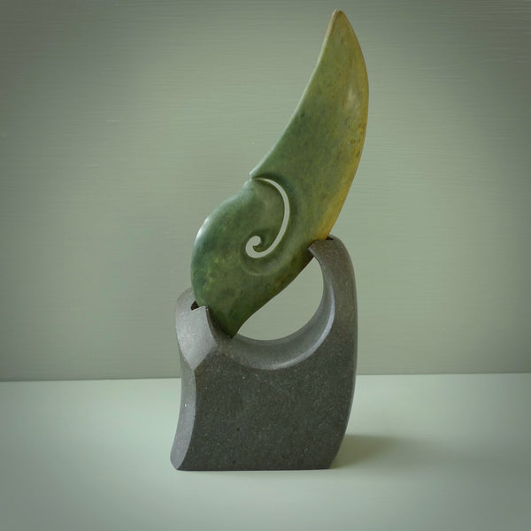 Hand carved New Zealand Flower Jade koru with Greywacke stand sculpture. Hand carved in New Zealand by Ric Moor. This is a one only sculpture and is a beautiful, large, display piece.