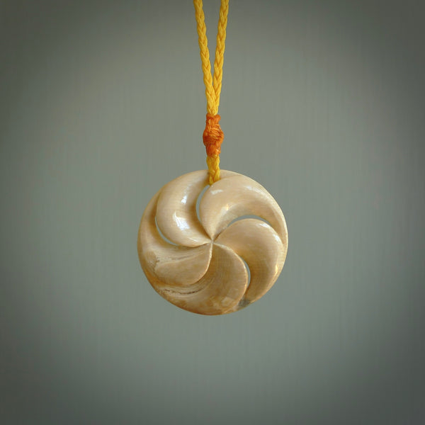 Hand carved woolly mammoth tusk, koru shaped pendant. Hand made by NZ Pacific. Handmade jewellery.