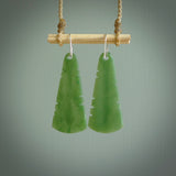 This picture shows New Zealand Pounamu, jade feather earrings with sterling silver hooks. Hand made unique and contemporary feather earrings by Kerry Thompson. Hand carved here in New Zealand from New Zealand Jade. One pair only.