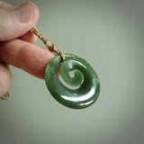 This pendant is a medium sized and gorgeous koru necklace carved from a deep green piece of New Zealand  Jade. Ross Crump carved this piece for us so the workmanship is outstanding. Handmade in New Zealand, a beautiful piece of jade jewellery.