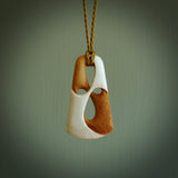 A hand carved bone contemporary, intricate, twist pendant. The cord is a tan colour and is adjustable. A medium sized hand made contemporary necklace by New Zealand artist Tonijae Brockway. Tonijae has stained parts of the bone which really add to the dimension of this pendant. One off work of art to wear.