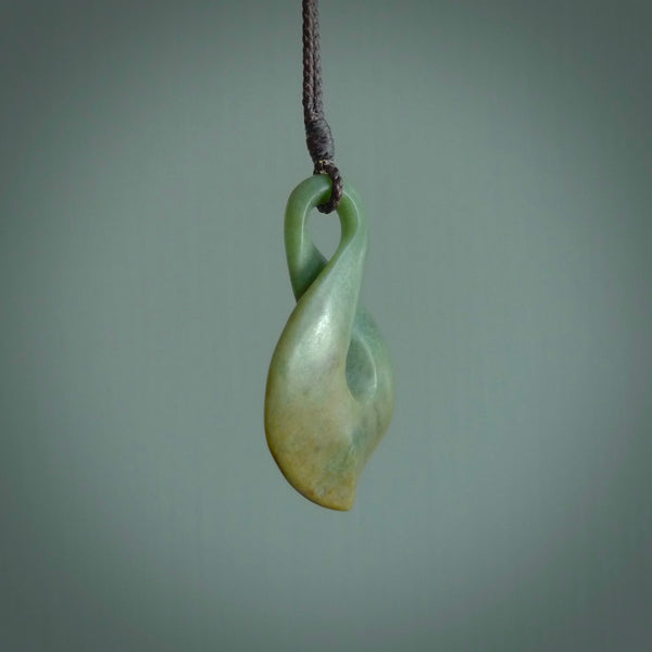 Hand carved medium sized, New Zealand jade twist pendant. Carved in New Zealand by NZ Pacific. Māori themed jewellery for sale online.