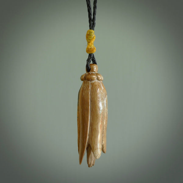 Hand carved Kowhai flower. These are made from Woolly Mammoth tusk and are a soft golden brown colour. They are provided with a hand plaited, adjustable cord. Shipping is free worldwide.