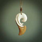 A hand carved bone contemporary, intricate pendant. The cord is tan colour and is adjustable. A medium sized hand made contemporary necklace by New Zealand artist Tonijae Brockway. Tonijae has stained parts of the bone which really add to the dimension of this pendant. One off work of art to wear.