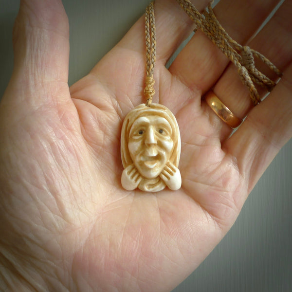 Hand carved incredible stained bone gargoyle face carving. A stunning work of art. This pendant was hand carved in bone with buffalo horn inlay for the eyes by Yuri Terenyi. A one off collectors item that has been hand crafted to be worn or displayed.