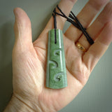 Hand made New Zealand jade drop with koru pendant. Hand carved in New Zealand by Kerry Thompson. Hand made jewellery. Unique large Jade drop with fixed length tan coloured cord. Free shipping worldwide.