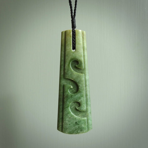 Hand made New Zealand jade drop with koru pendant. Hand carved in New Zealand by Kerry Thompson. Hand made jewellery. Unique large Jade drop with fixed length black coloured cord. Free shipping worldwide.