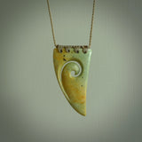 Hand carved New Zealand Flower jade niho, fang, pendant with Koru heart centre. Carved by New Zealand artist Ric Moor. Contemporary New Zealand Jade fang, drop necklace with Koru centre. One only unique pendant for men and women.