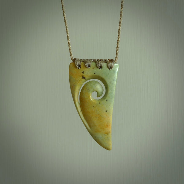 Hand carved New Zealand Flower jade niho, fang, pendant with Koru heart centre. Carved by New Zealand artist Ric Moor. Contemporary New Zealand Jade fang, drop necklace with Koru centre. One only unique pendant for men and women.