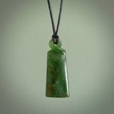 This pendant is a flower jade single twist. It is handcarved from New Zealand flower jade and has a mix of green, mint and pale gold colours interspersed throughout the stone. It has a fine twist, small and light. The cord is hand plaited and can be adjusted. The cord colour on this piece is Khaki. Two sizes available.