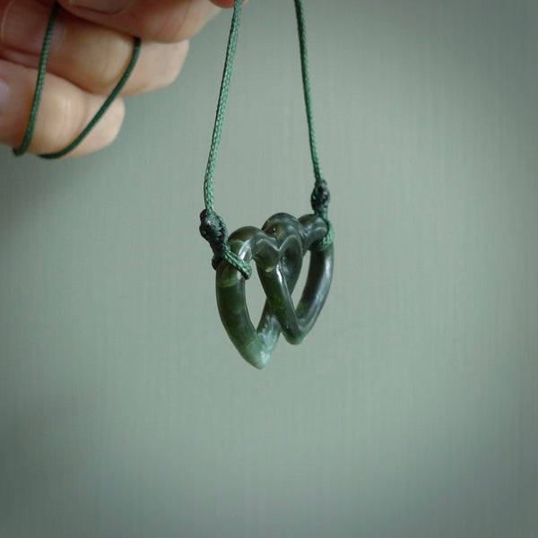 Hand carved double heart pendant made in black jade, green jade and jasper stone. Made by NZ Pacific. Carved from green jade, black jade and red jasper stone. Free delivery worldwide.