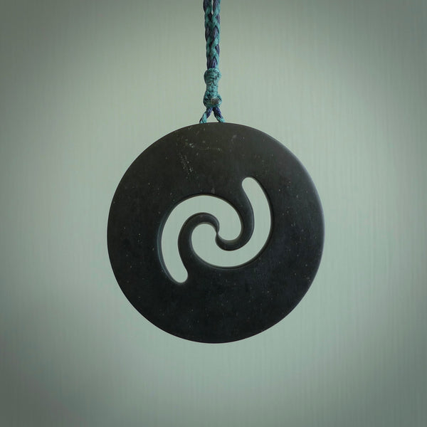 Hand made large New Zealand Pounamu, Jade Koru pendant. Hand carved in New Zealand by Rueben Tipene. Hand made jewellery. Unique large Greenstone Koru with adjustable cobalt blue/maui blue cord. Free shipping worldwide.