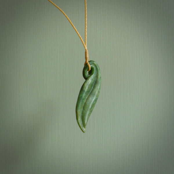 This is a unique flower pendant, hand carved from New Zealand Jade. The cord is a creme colour and is length adjustable. This is delivered to you with Express Courier. Hand carved Jade necklace replicating a flower blossom from Donna Summers.