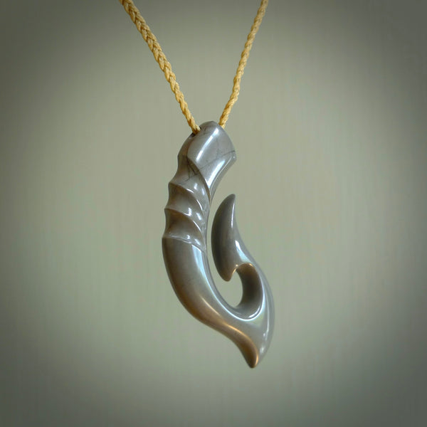 Hand made medium New Zealand Argillite Matau, hook pendant. Hand carved in New Zealand by Kerry Thompson. Hand made jewellery. Unique medium Argillite Stone matau with adjustable cord. Free shipping worldwide.