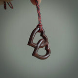 Hand carved double heart pendant made in black jade, green jade and jasper stone. Made by NZ Pacific. Carved from green jade, black jade and red jasper stone. Free delivery worldwide.