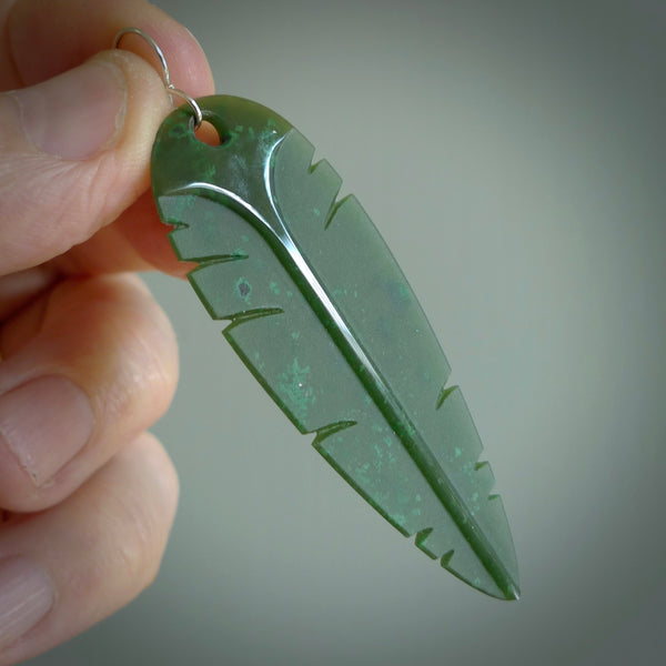 This picture shows British Columbian jade kaka feather earrings with sterling silver hooks. Hand made unique and contemporary feather earrings by Kerry Thompson. Hand carved here in New Zealand from British Columbian Jade. One pair only.