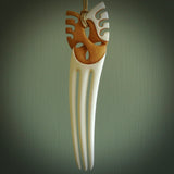 A hand carved bone and stained bone Heru comb. A large hand made Heru comb by New Zealand artist Kerry Thompson. Kerry has carved an exquisite work of art and would be perfect for an enthusiasts collection.