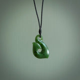 This picture shows a jade hook pendant, also called a hei-matau, carved for us in New Zealand jade. The carver is Ric Moor - and this is a beautiful example of his work. The cord is a four-plait, adjustable black coloured necklace.