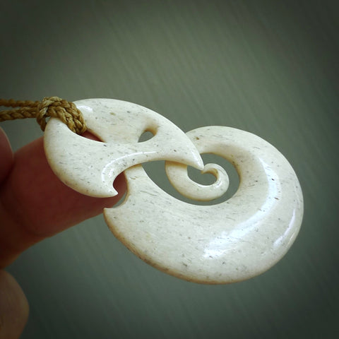 A hand carved path of life design pendant from Whale Bone. The cord tan and is adjustable. Large hand made Koru necklaces by New Zealand artist Kerry Thompson.