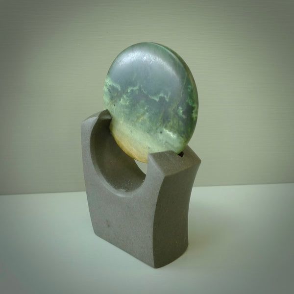 Hand carved New Zealand Marsden Jade Disc with Greywacke stand sculpture. Hand carved here in New Zealand by Ric Moor. This is a 'one only' sculpture, a beautiful display piece.