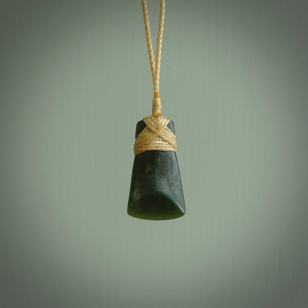 Hand carved jade toki by Ric Moor. Made in New Zealand by NZ Pacific. Hand carved Toki pendants crafted from beautiful New Zealand Pounamu, Jade. We deliver these with Express Courier, on adjustable cords.
