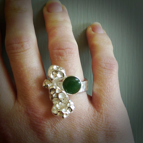 This is a handcrafted New Zealand Pounamu, Jade and sterling silver ring. This is a solid little work of art. We ship this worldwide for free and are happy to answer any questions that you may have about these or other products on our website.