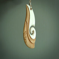 A hand carved bone contemporary, intricate pendant. The cord is a 4 strand, 3 plait in Ice White and Tan and is an adjustable length. A large sized hand made contemporary necklace by New Zealand artist Kerry Thompson. Kerry has stained parts of the bone which really add to the dimension of this pendant. One of work of art to wear.