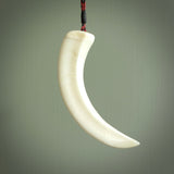 Hand carved whale pendant, carved by us. This piece is carved from boars tusk and is a fantastic depiction of these giants of the deep. This particular piece is a whale design and is lovingly carved.