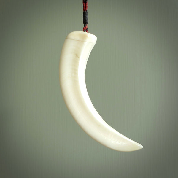 Hand carved whale pendant, carved by us. This piece is carved from boars tusk and is a fantastic depiction of these giants of the deep. This particular piece is a whale design and is lovingly carved.