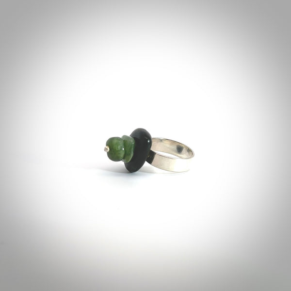 This is a handcrafted New Zealand Marsden jade stack ring with sterling silver. The colours are a deep and light green. This is a solid little work of art. We ship this worldwide for free and are happy to answer any questions that you may have about these or other products on our website.