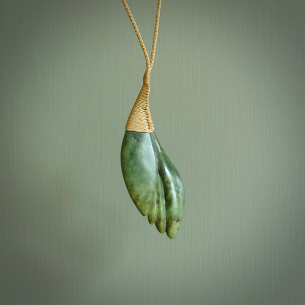 This is a unique flower pendant, hand carved from New Zealand Jade. The cord is a creme colour and is length adjustable. This is delivered to you with Express Courier. Hand carved Jade necklace replicating a flower blossom from Donna Summers.