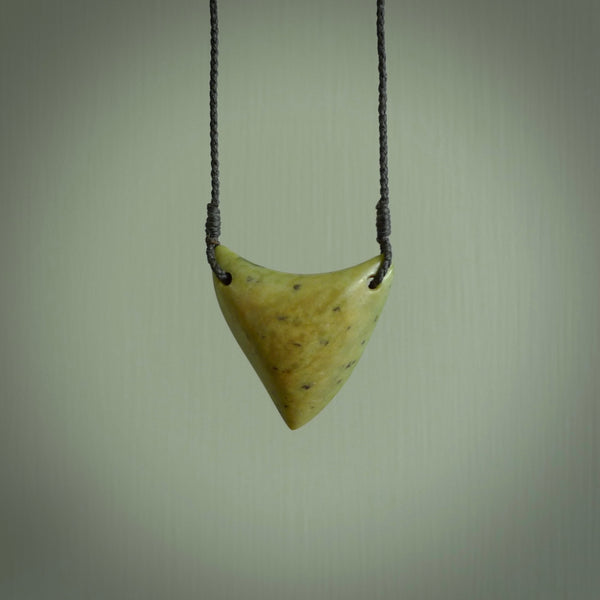 This is a lovely New Zealand Jade, pounamu drop pendant. Hand carved for us by Ric Moor. It is bound with an adjustable black coloured cord which is length adjustable. Free worldwide shipping.
