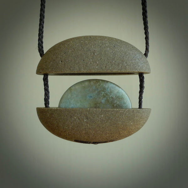 Greywacke stone pendant with Aotea Stone insert. Hand carved by Rhys Hall for NZ Pacific. Handmade contemporary jewellery for sale online.