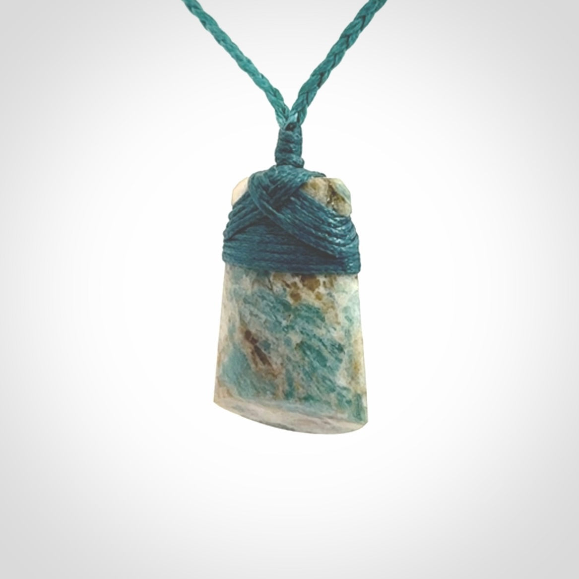 This is a handcrafted aotea stone Toki pendant.
