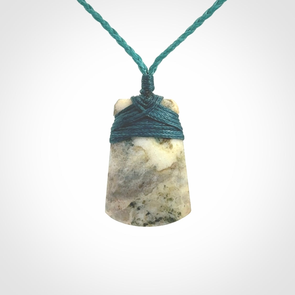 This is a handcrafted aotea stone Toki pendant.