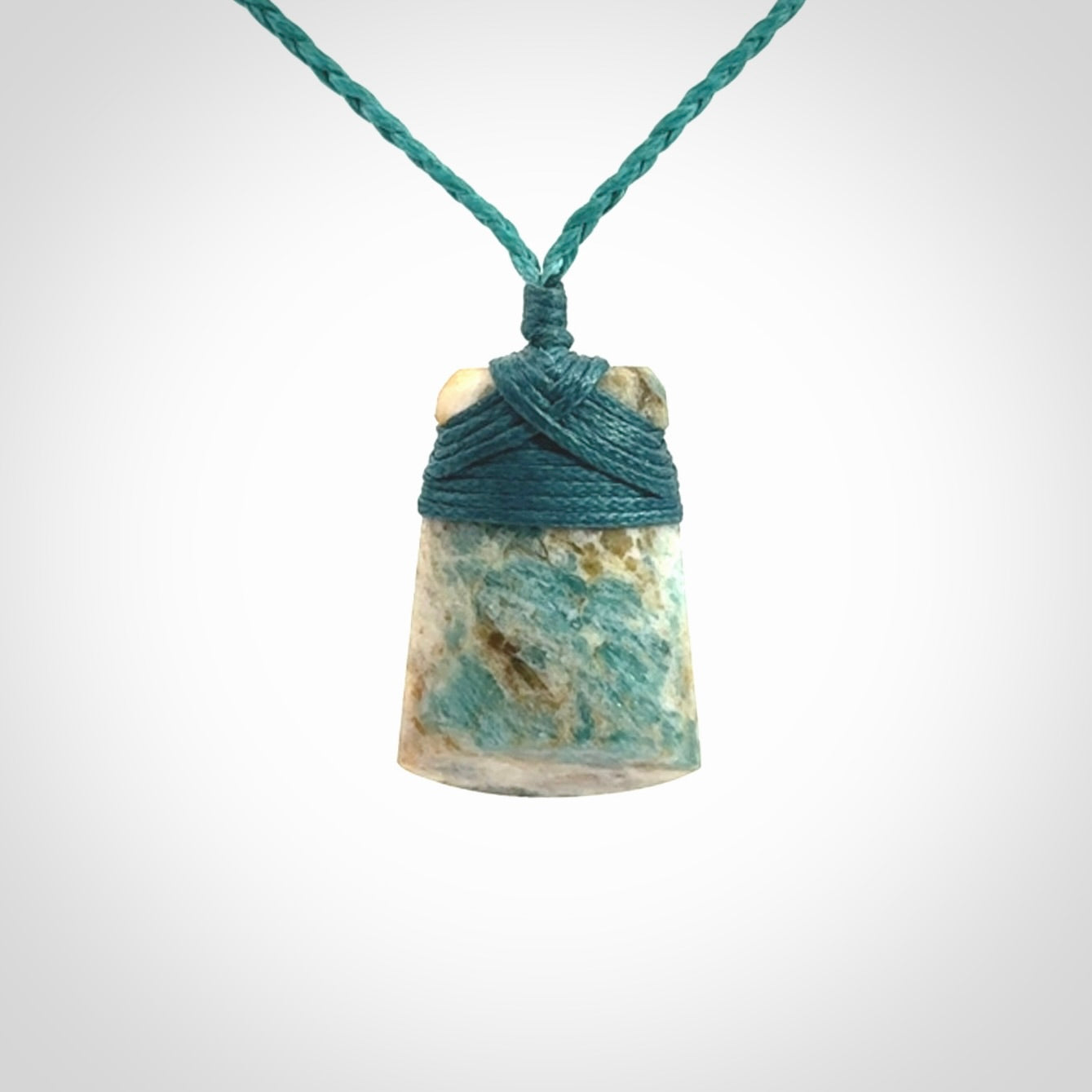 This is a handcrafted aotea stone Toki pendant.