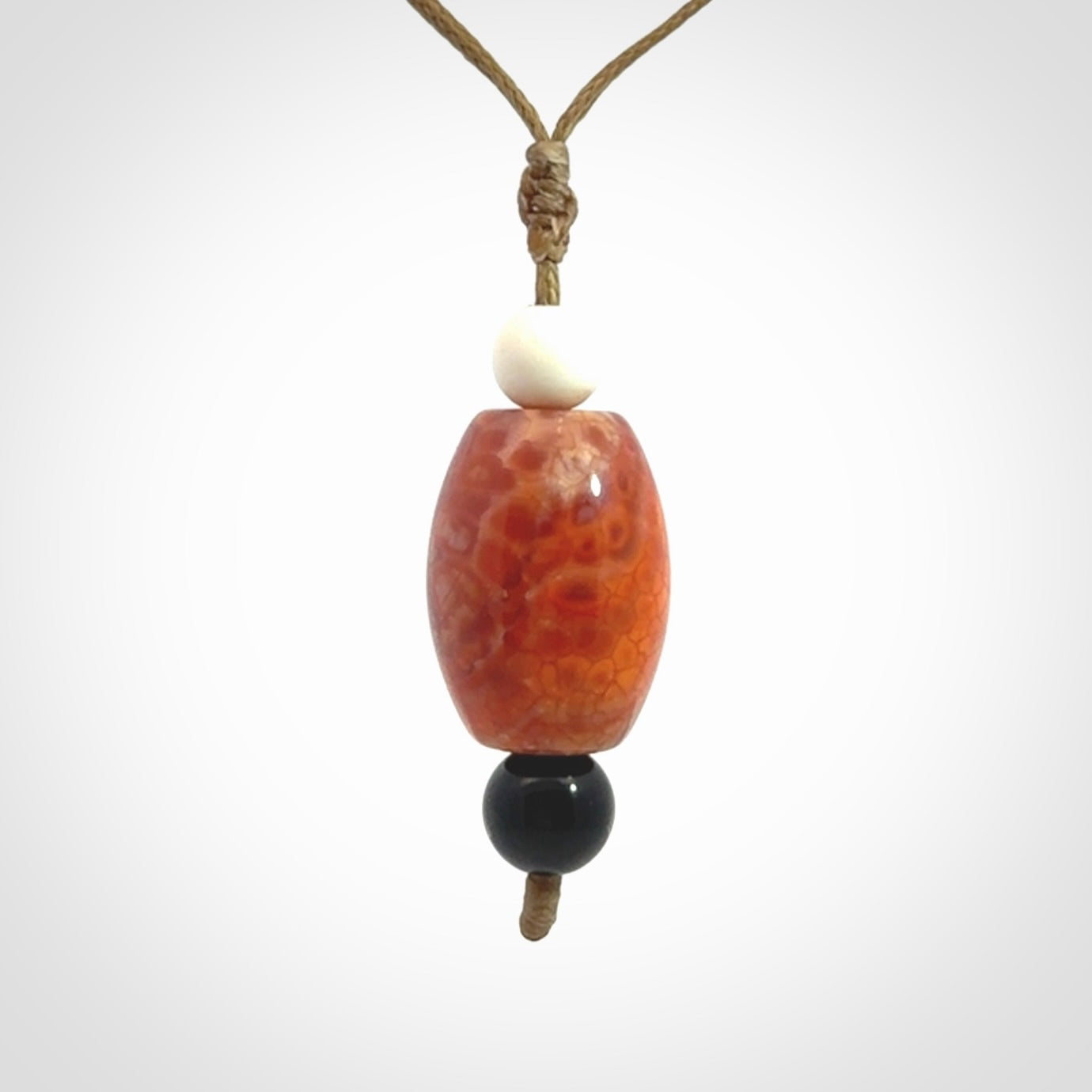 Snakeskin Agate contemporary drop pendant with black jade and woolly mammoth tusk beads. Hand carved for you by NZ Pacific.