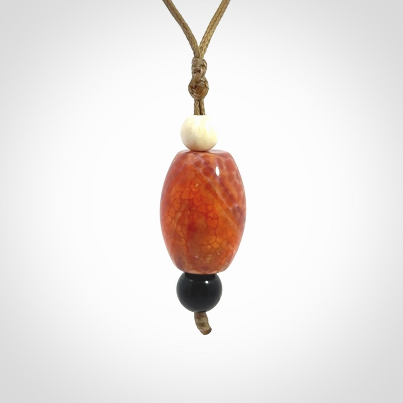 Snakeskin Agate contemporary drop pendant with black jade and woolly mammoth tusk beads. Hand carved for you by NZ Pacific.