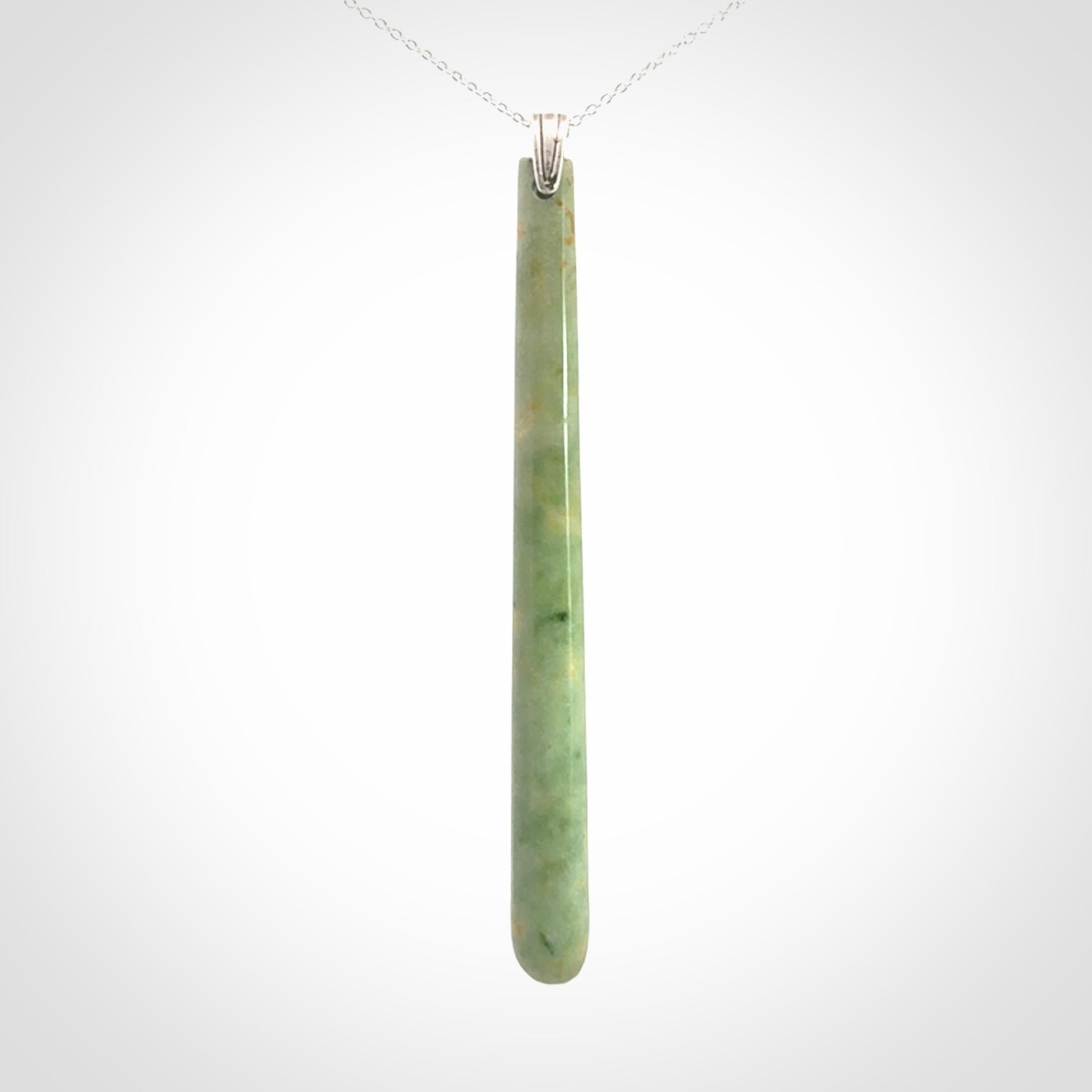 A hand carved New Zealand Jade Drop pendant with sterling silver clasp and chain.