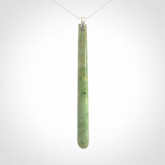 A hand carved New Zealand Jade Drop pendant with sterling silver clasp and chain.