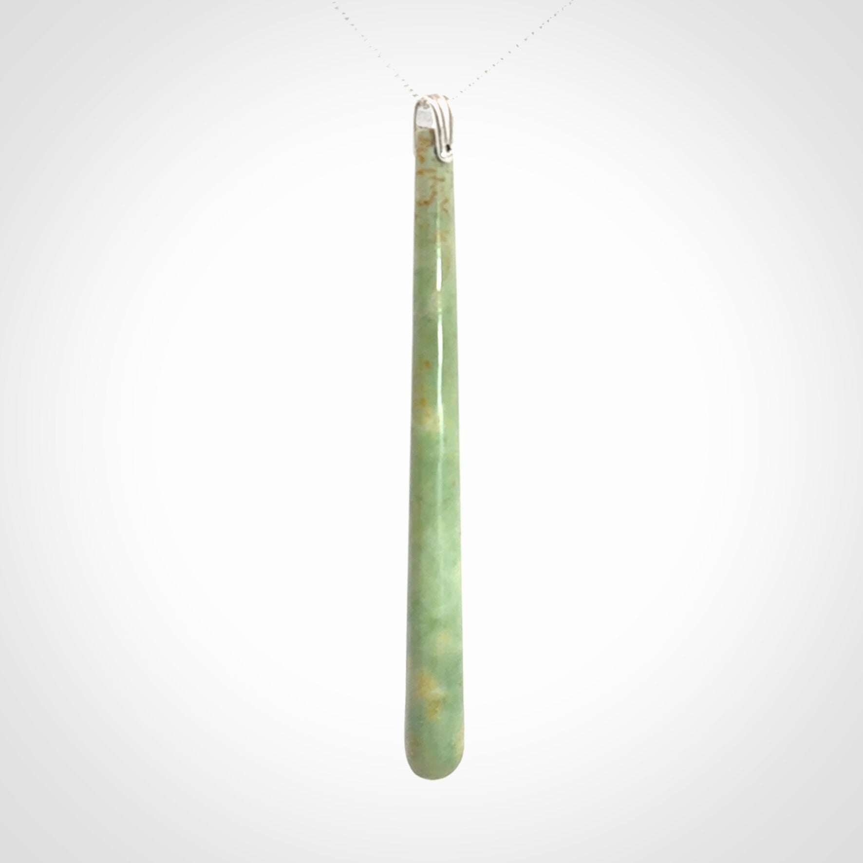 A hand carved New Zealand Jade Drop pendant with sterling silver clasp and chain.