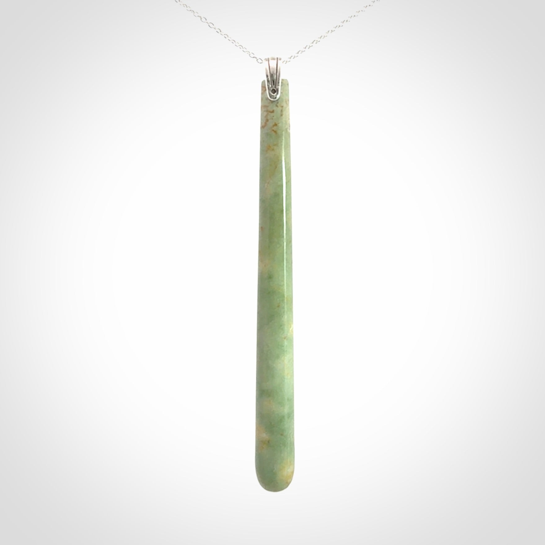 A hand carved New Zealand Jade Drop pendant with sterling silver clasp and chain.