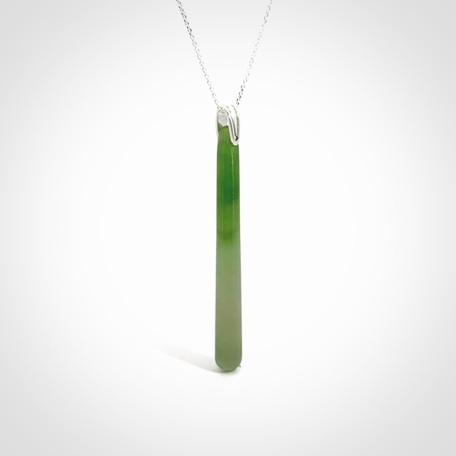 A hand carved New Zealand Jade Drop pendant with sterling silver clasp and chain.