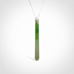 A hand carved New Zealand Jade Drop pendant with sterling silver clasp and chain.