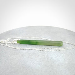A hand carved New Zealand Jade Drop pendant with sterling silver clasp and chain.