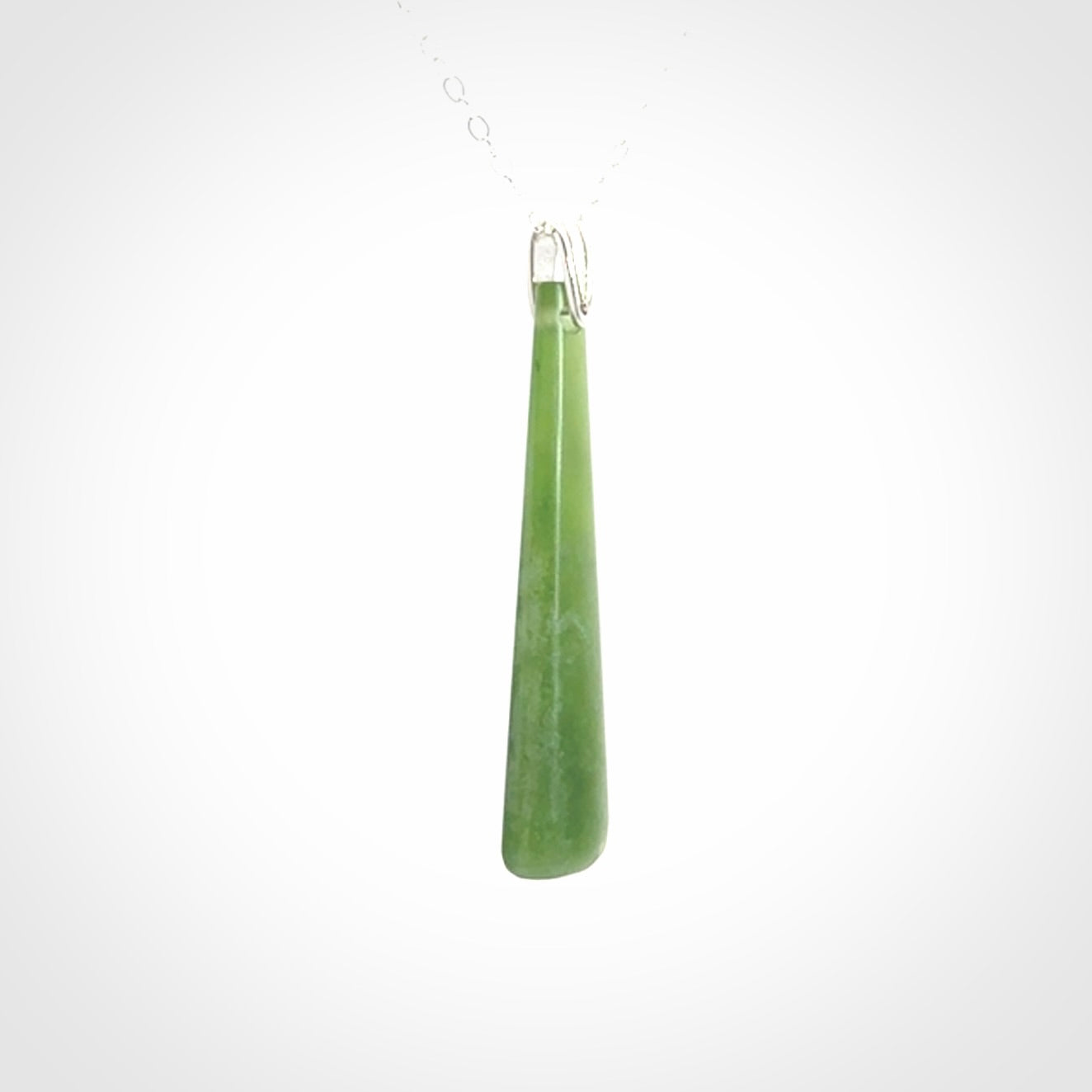 A hand carved New Zealand Jade Drop pendant with sterling silver clasp and chain.