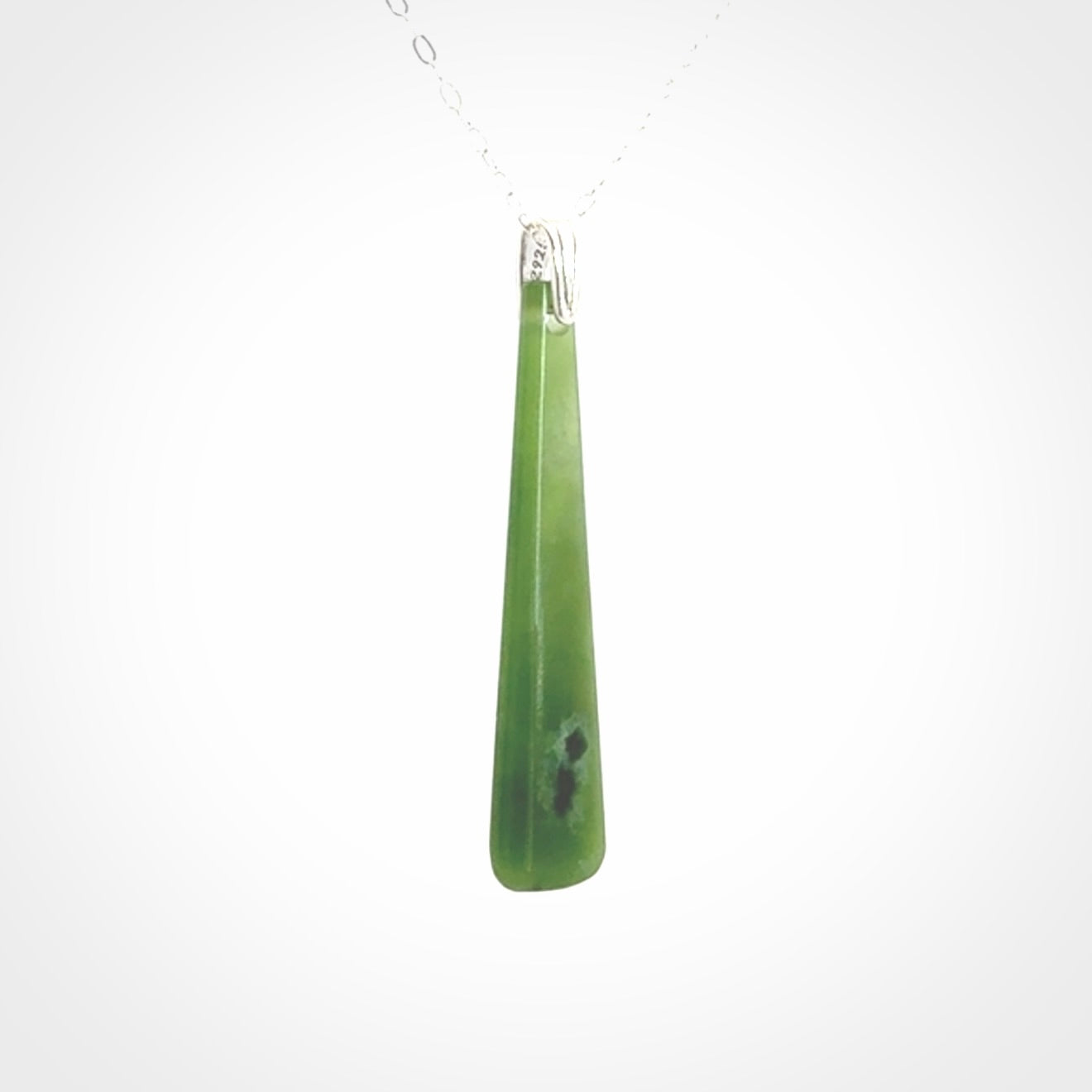 A hand carved New Zealand Jade Drop pendant with sterling silver clasp and chain.