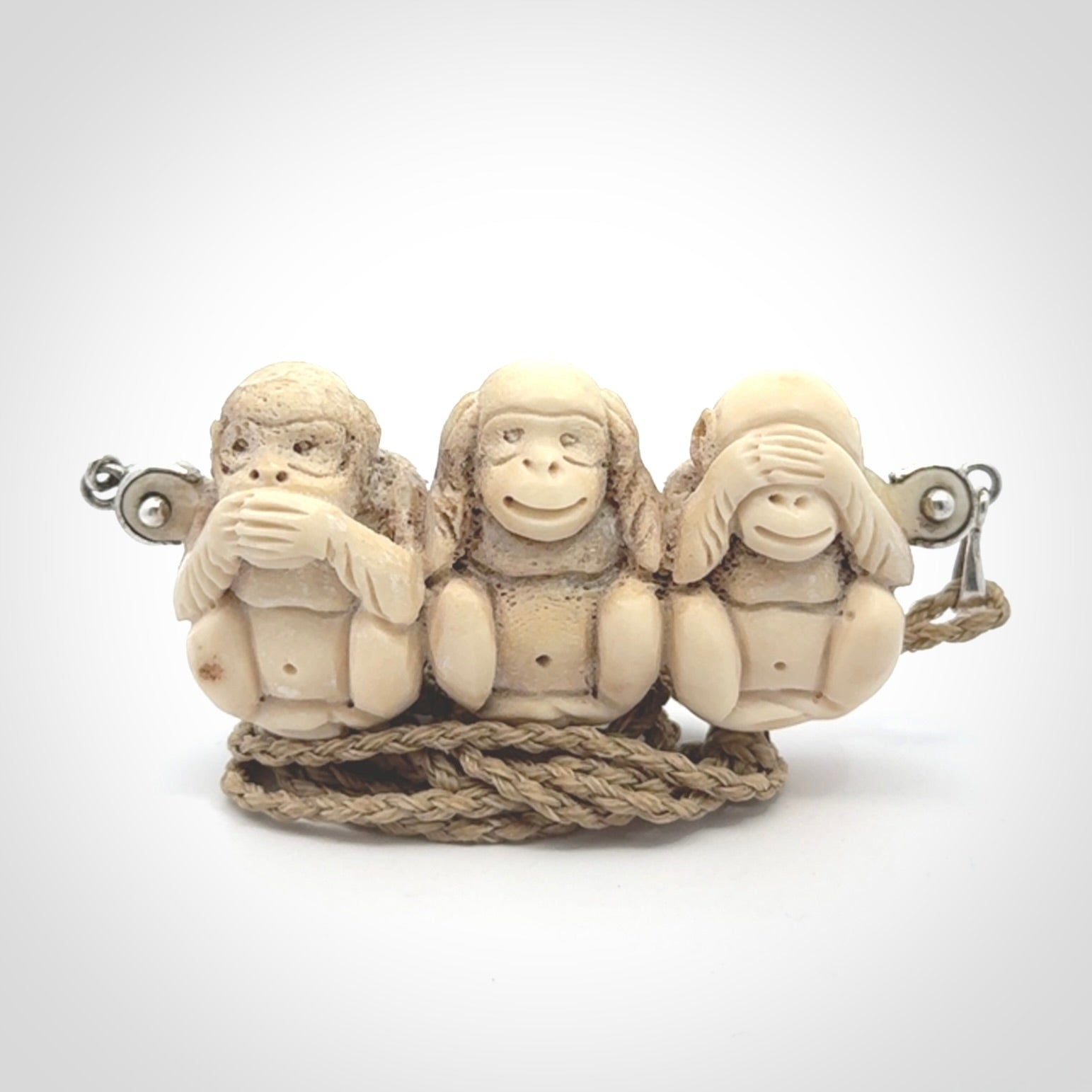 This is a hand carved deer antler three wise monkeys pendant. It is made from deer antler, bone. This is a large sized necklace and is a very unique, one only, pendant that has an adjustable tan cord. Hand carved deer antler three wise monkeys necklace for men and women. Hear, Speak, See no evil monkey pendant.